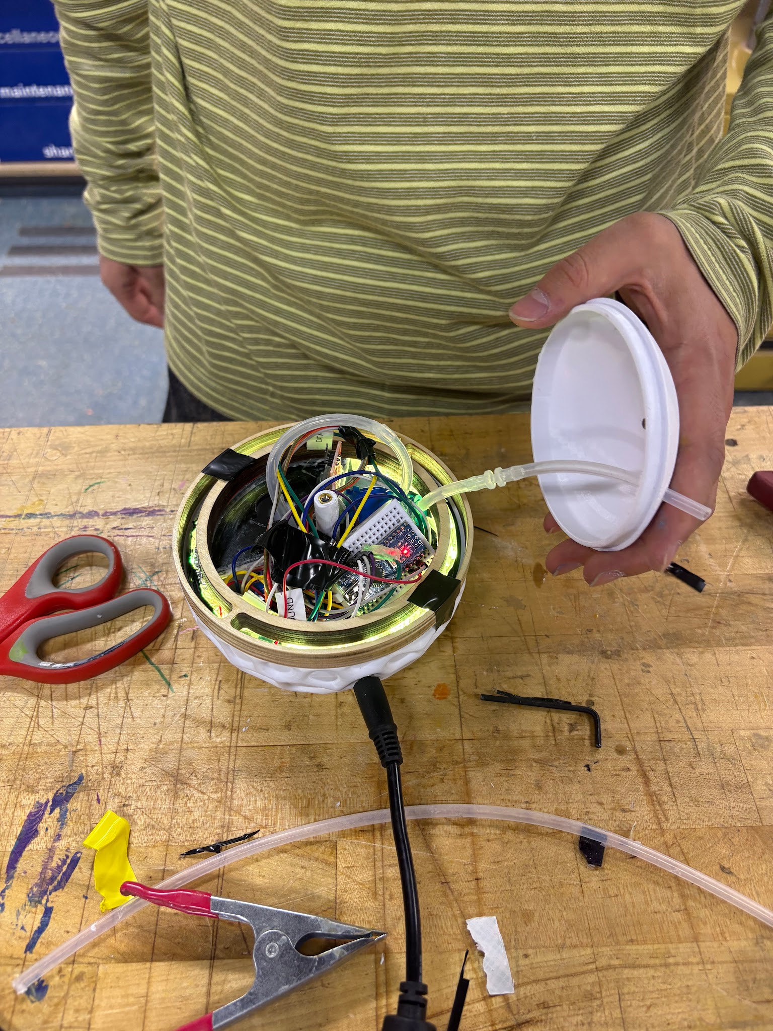 Opened lamp base showing electronics assembly during testing