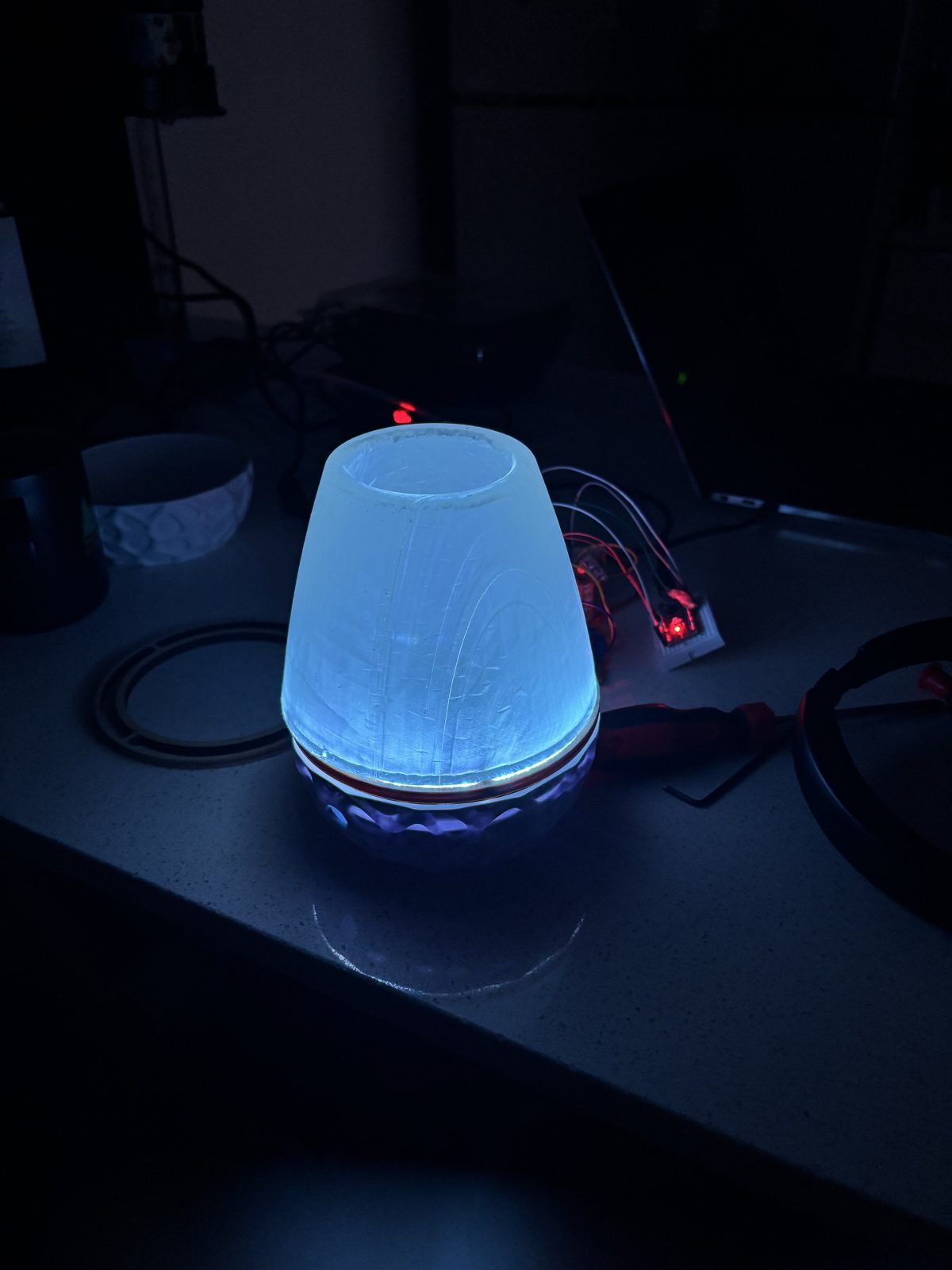 Lamp glowing blue-white in a dark room