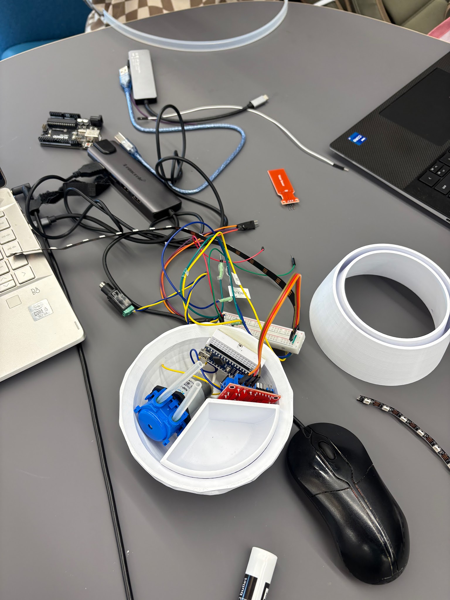 Electronics components including Arduino, pump, and wiring