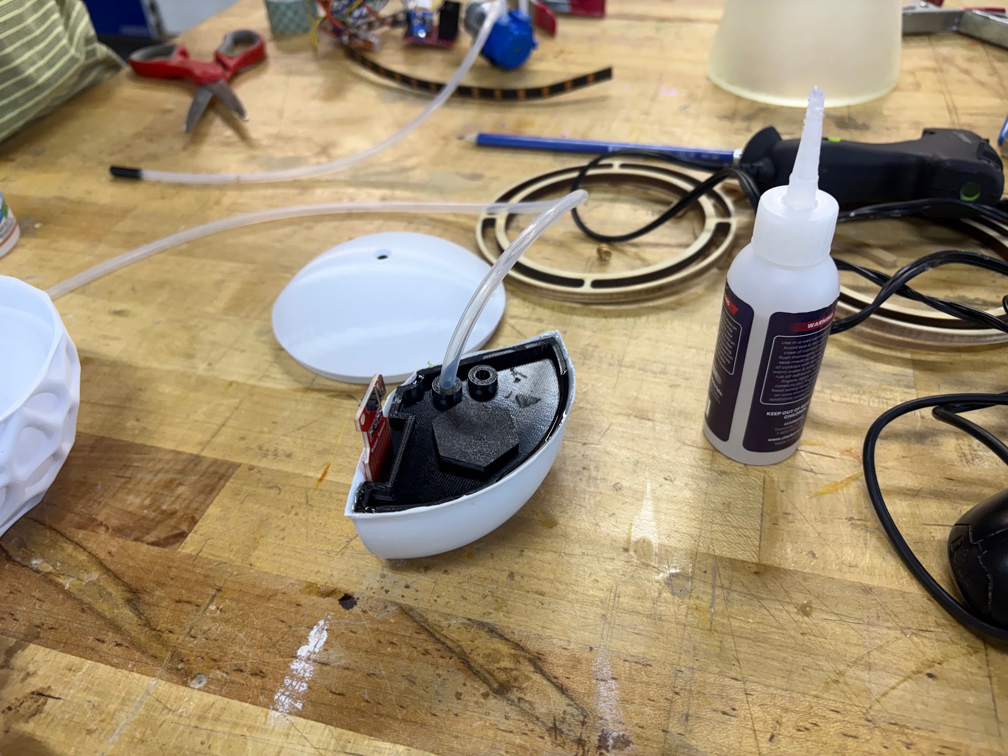Vacuum-formed shell with internal electronics being assembled